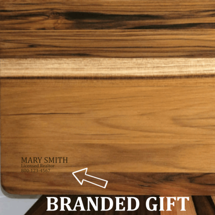 back of charcuterie board as a gift to new homeowner, branded with realtor information