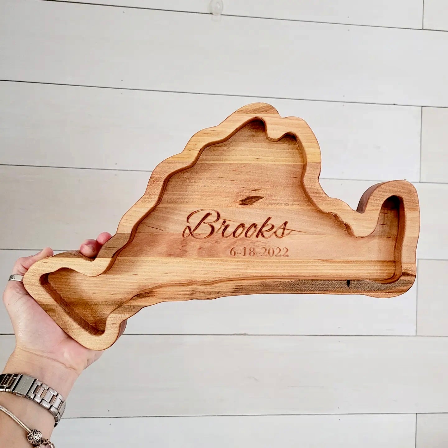 artha's Vineyard-shaped charcuterie board engraved with family name, showcasing fine craftsmanship and natural beauty