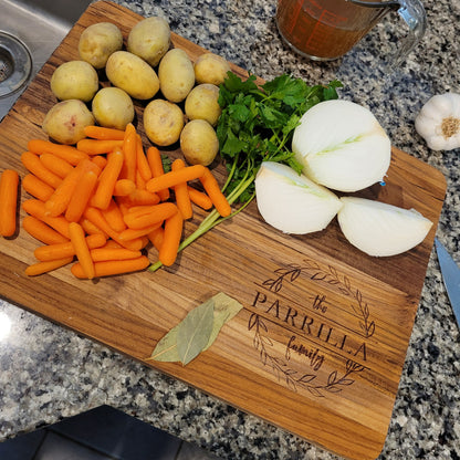 teakwood cutting board with stew ingredients on it. Board personalized with family name