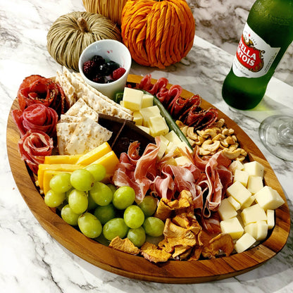 personalized football-shaped wooden charcuterie board