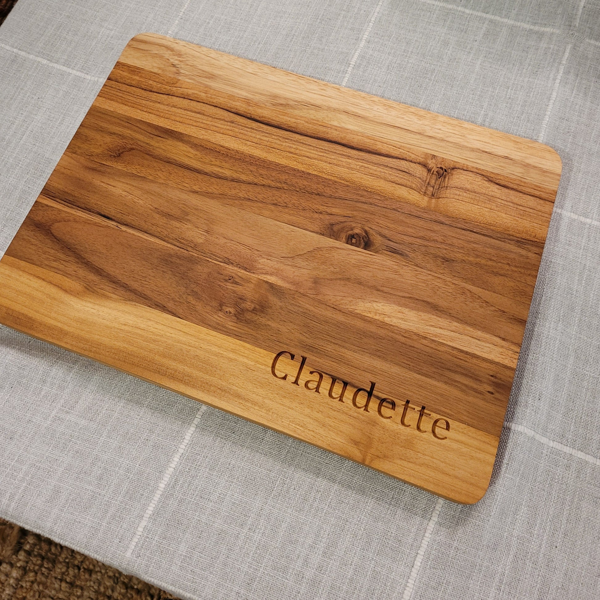 teakwood cutting board engraved with a name