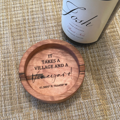 wooden wine coaster with intricate engraving it takes a vineyard