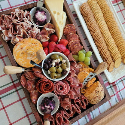 large charcuterie board loaded with an array of cheese, meat, fruit and more