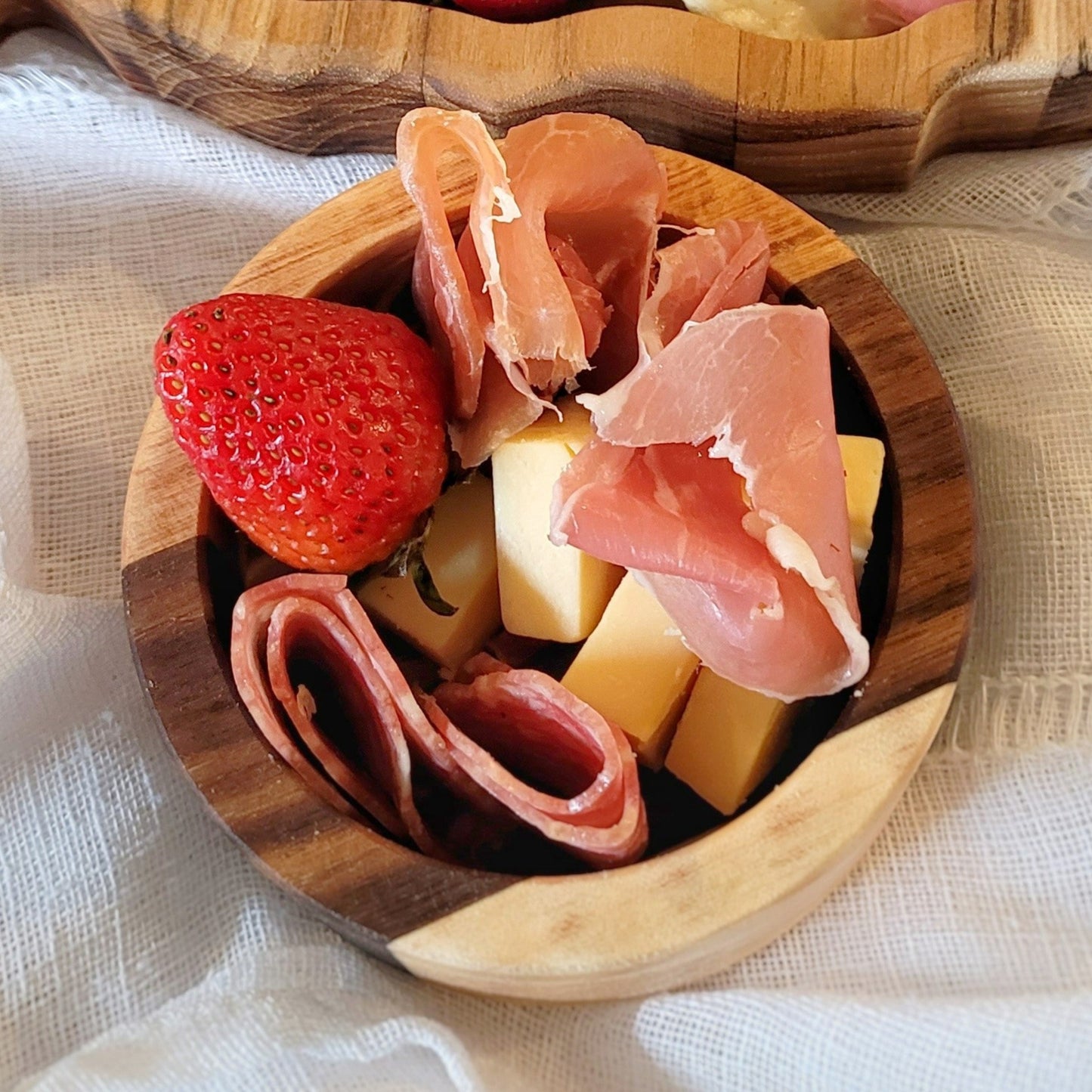 Close-up of rustic wooden charcuterie bowl